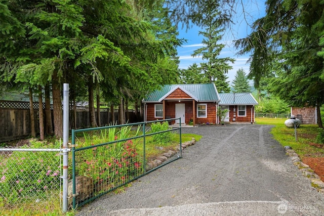 6258 Bellwood Dr, Maple Falls, WA 98266 - view of front of property featuring a metal roof, dirt driveway, and a gate