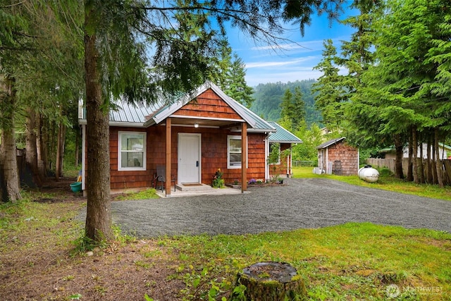 6258 Bellwood Dr, Maple Falls, WA 98266 - view of front of home with a metal roof, an outdoor structure, and a standing seam roof