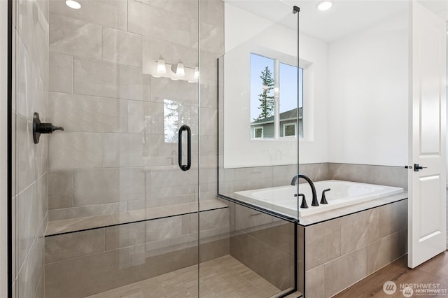 13937 181st St E Unit 8, Puyallup, WA 98374 - bathroom featuring a garden tub, a stall shower, and wood finished floors