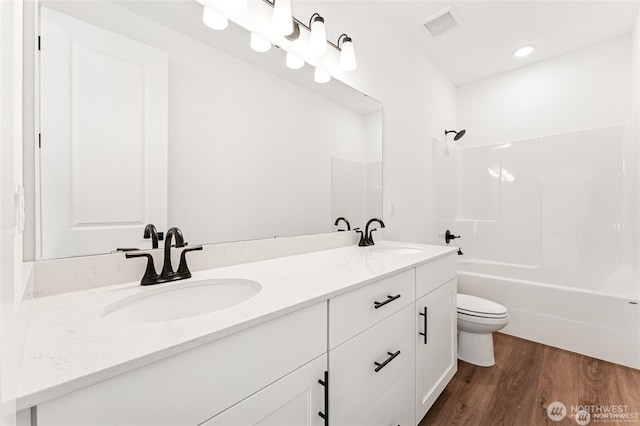13937 181st St E Unit 8, Puyallup, WA 98374 - bathroom with double vanity, wood finished floors, and bathtub / shower combination