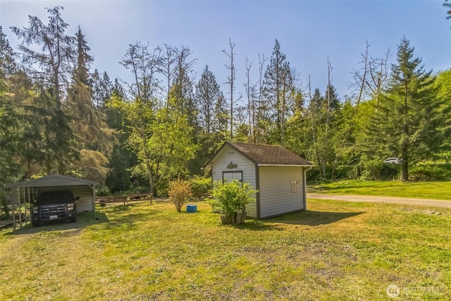 3863 Paradise Bay Rd, Port Ludlow, WA 98365 - view of green lawn with a storage unit and a detached carport