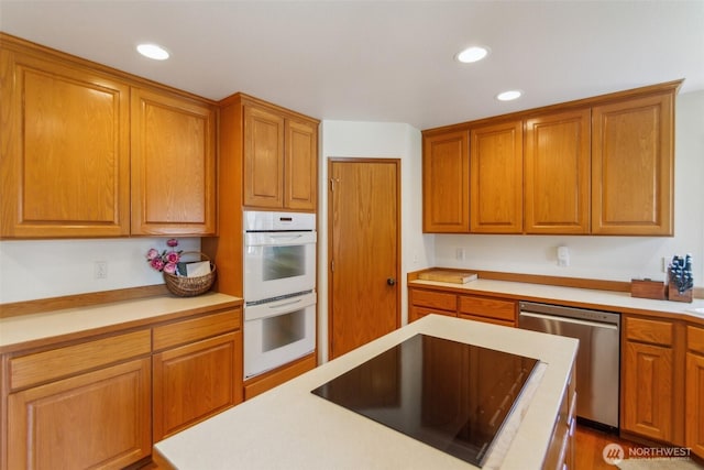 3863 Paradise Bay Rd, Port Ludlow, WA 98365 - kitchen with stainless steel dishwasher, double oven, black electric cooktop, light countertops, and recessed lighting