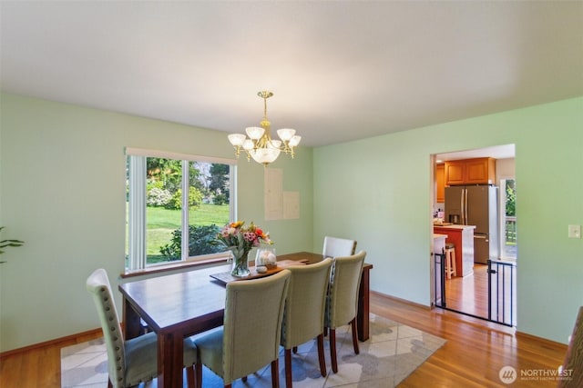3863 Paradise Bay Rd, Port Ludlow, WA 98365 - dining room with a chandelier and light wood-style flooring