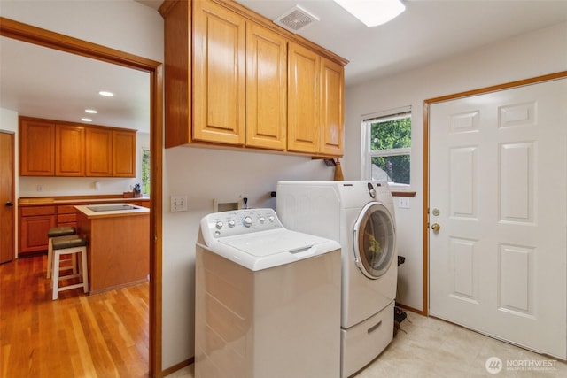 3863 Paradise Bay Rd, Port Ludlow, WA 98365 - washroom featuring washer and clothes dryer, cabinet space, recessed lighting, and light wood-style floors