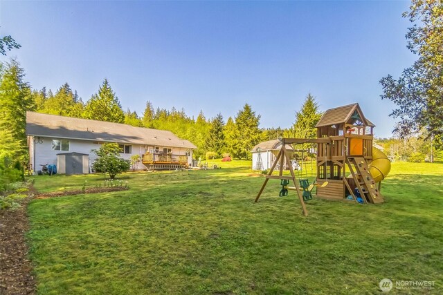 3863 Paradise Bay Rd, Port Ludlow, WA 98365 - view of green lawn featuring a shed, a playground, and a deck
