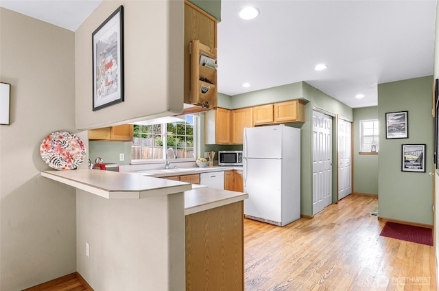 2616 16th St, Bellingham, WA 98229 - kitchen with white appliances, a peninsula, healthy amount of natural light, light countertops, and recessed lighting