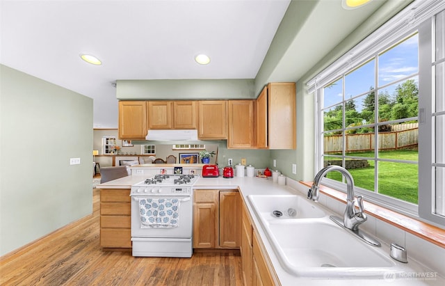 2616 16th St, Bellingham, WA 98229 - kitchen featuring white gas stove, light wood finished floors, light countertops, a peninsula, and recessed lighting