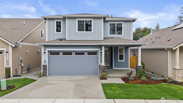 1401 89th Ave SE, Tumwater, WA 98501 - view of front of home with board and batten siding, concrete driveway, a garage, covered porch, and stone siding