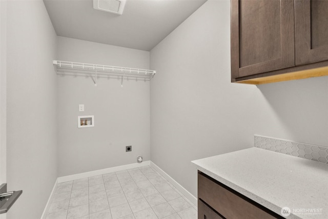 1401 89th Ave SE, Tumwater, WA 98501 - laundry area featuring cabinet space, washer hookup, electric dryer hookup, and light tile patterned floors