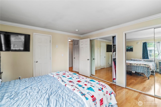 17306 NE 45th St Unit 116, Redmond, WA 98052 - bedroom with multiple closets, light wood-style floors, and crown molding