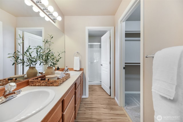 9323 4th Ave W, Everett, WA 98204 - full bathroom featuring a shower stall, double vanity, wood finished floors, and a walk in closet