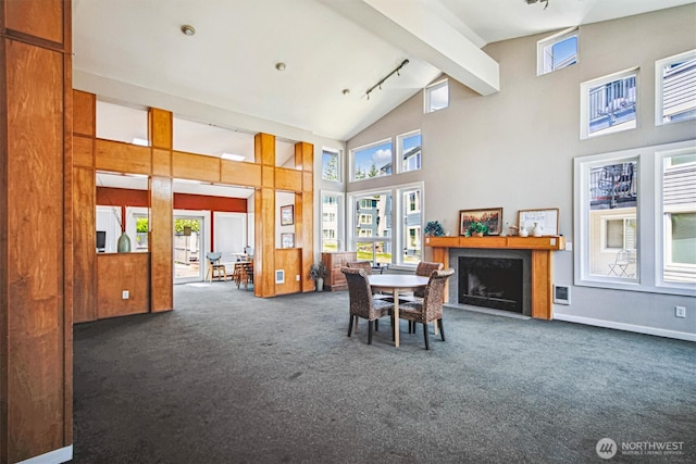 26327 116th Ave SE Unit E102, Kent, WA 98030 - carpeted dining space with healthy amount of natural light, high vaulted ceiling, track lighting, beamed ceiling, and a fireplace