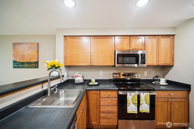 26327 116th Ave SE Unit E102, Kent, WA 98030 - kitchen featuring appliances with stainless steel finishes, dark countertops, brown cabinetry, and recessed lighting