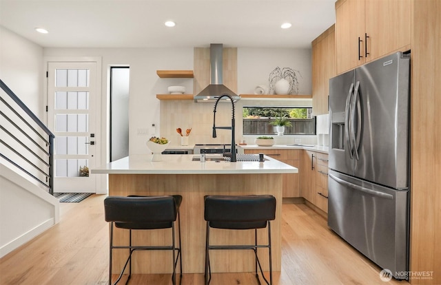1120 NW 61st St Unit B, Seattle, WA 98107 - kitchen featuring stainless steel fridge, wall chimney range hood, light brown cabinetry, open shelves, and light countertops