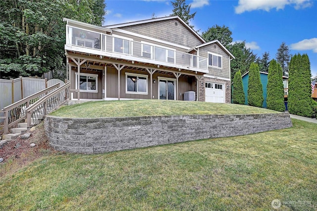 2102 256th St NW, Stanwood, WA 98292 - back of property with an attached garage, a wooden deck, and board and batten siding
