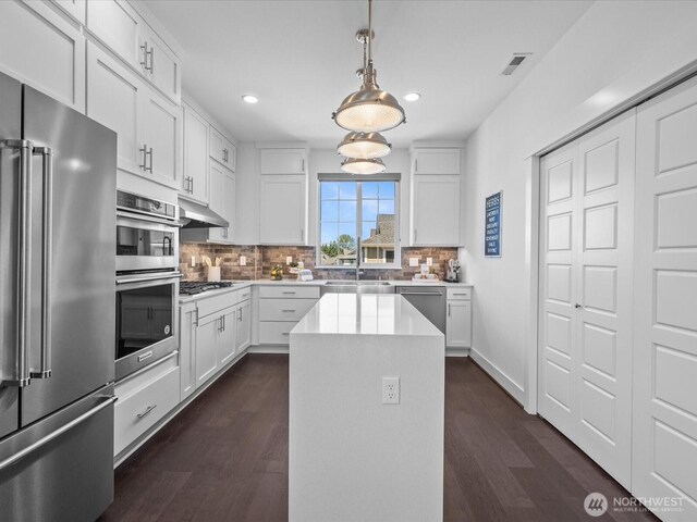 14031 3rd Ave NE, Duvall, WA 98019 - kitchen featuring appliances with stainless steel finishes, recessed lighting, decorative backsplash, light countertops, and dark wood-style flooring