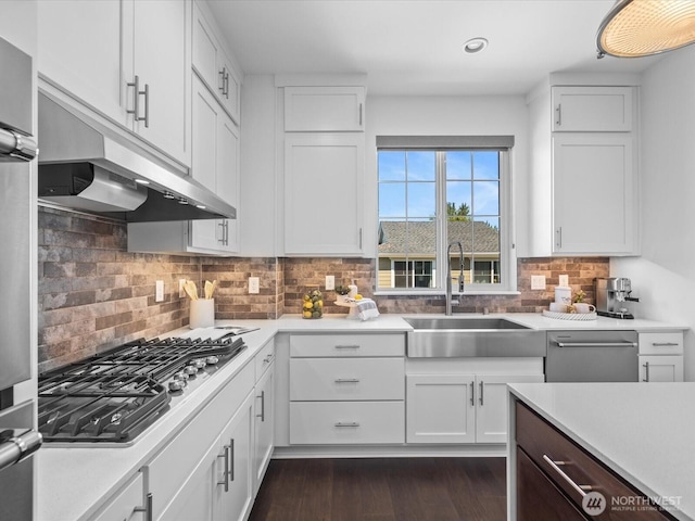 14031 3rd Ave NE, Duvall, WA 98019 - kitchen with under cabinet range hood, stainless steel appliances, light countertops, white cabinets, and recessed lighting