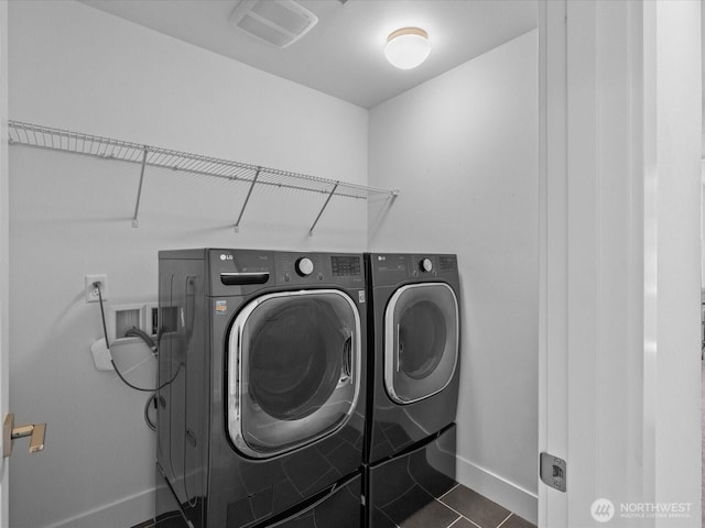 14031 3rd Ave NE, Duvall, WA 98019 - washroom featuring separate washer and dryer and dark tile patterned flooring