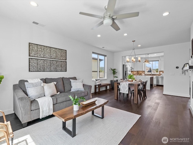 14031 3rd Ave NE, Duvall, WA 98019 - living area featuring recessed lighting, healthy amount of natural light, a chandelier, dark wood-type flooring, and a ceiling fan