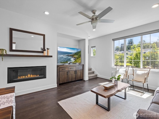 14031 3rd Ave NE, Duvall, WA 98019 - living room with recessed lighting, a glass covered fireplace, ceiling fan, wood finished floors, and stairs