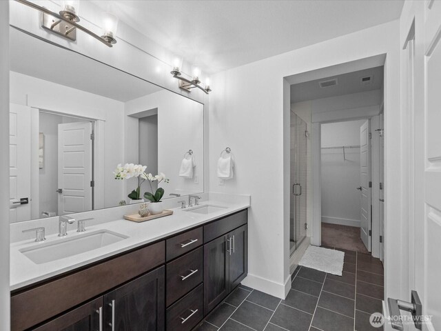 14031 3rd Ave NE, Duvall, WA 98019 - full bathroom featuring double vanity, a shower stall, tile patterned floors, and a spacious closet