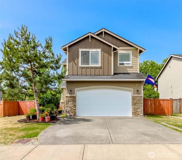 1605 Riddell Ave NE, Orting, WA 98360 - view of front facade featuring board and batten siding, stone siding, a garage, and driveway