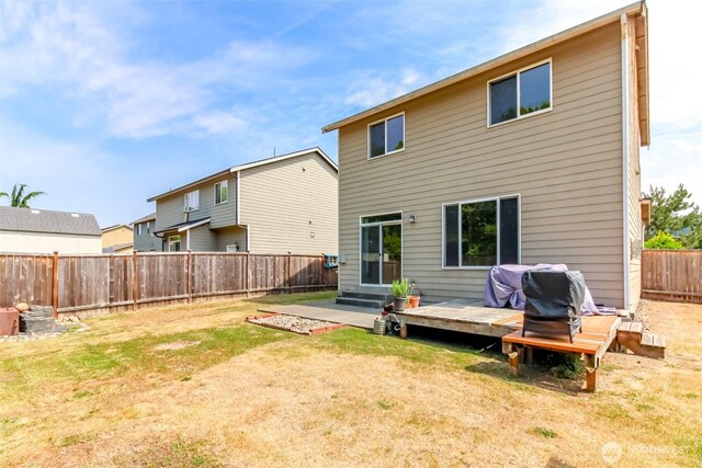 1605 Riddell Ave NE, Orting, WA 98360 - back of property with a fenced backyard and a deck