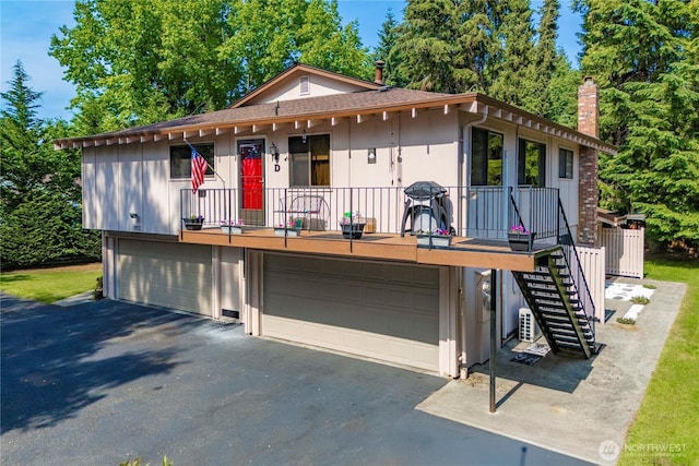 2822 Garden Ct Unit B, Steilacoom, WA 98388 - view of front of property featuring driveway, stairs, a chimney, and a garage