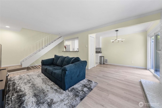 2822 Garden Ct Unit B, Steilacoom, WA 98388 - living room with a chandelier, light wood-style flooring, stairway, and ornamental molding