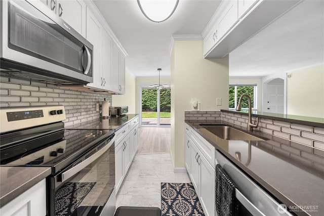 2822 Garden Ct Unit B, Steilacoom, WA 98388 - kitchen with appliances with stainless steel finishes, light marble finish flooring, dark countertops, backsplash, and white cabinetry