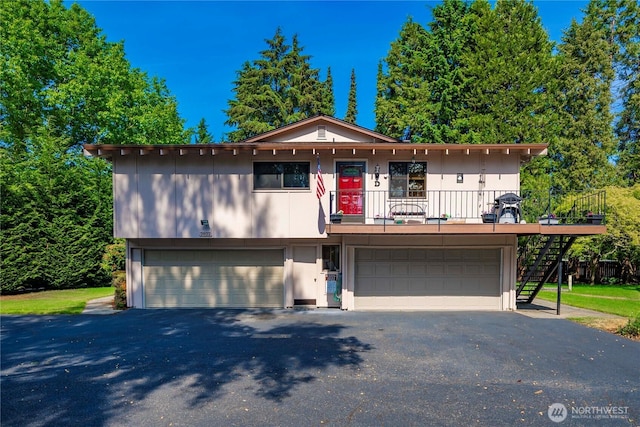 2822 Garden Ct Unit B, Steilacoom, WA 98388 - view of front of house with stairway, an attached garage, and asphalt driveway