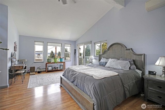 858 Westview Ct, Camano Island, WA 98282 - bedroom with an AC wall unit, access to exterior, wood finished floors, and high vaulted ceiling