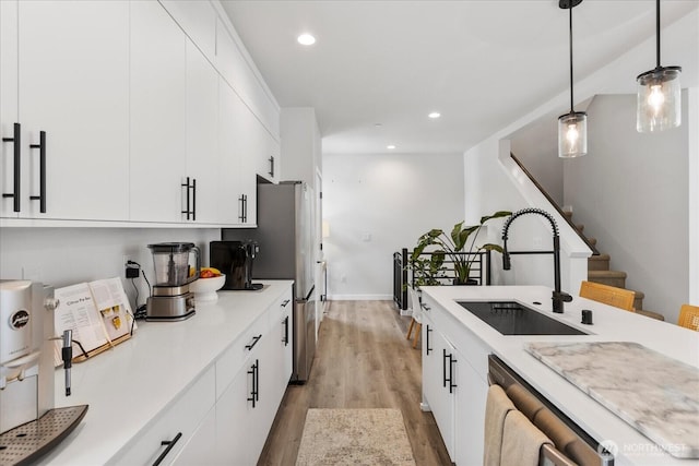 21511 50th Ave W Unit E, Mountlake Terrace, WA 98043 - kitchen featuring light wood-style flooring, light countertops, hanging light fixtures, white cabinetry, and recessed lighting
