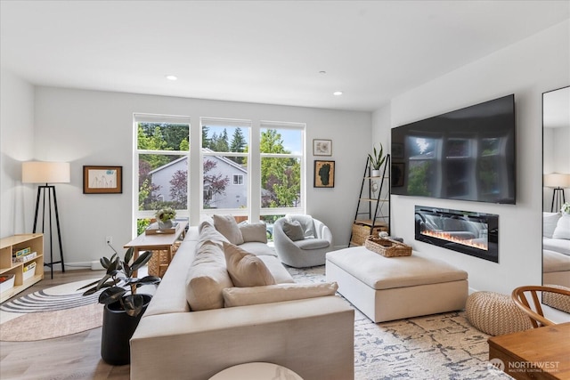 21511 50th Ave W Unit E, Mountlake Terrace, WA 98043 - living room with wood finished floors, a glass covered fireplace, and recessed lighting