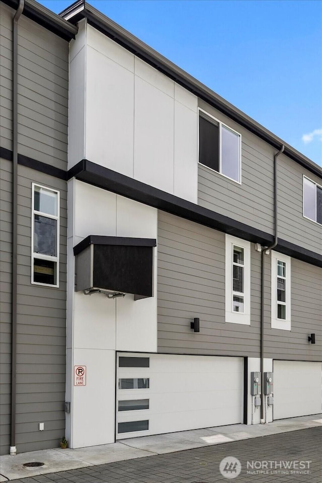 21511 50th Ave W Unit E, Mountlake Terrace, WA 98043 - view of side of home featuring an attached garage