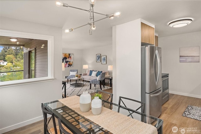 19428 N Aurora Ave Unit 236, Shoreline, WA 98133 - dining area featuring light wood-type flooring and baseboards