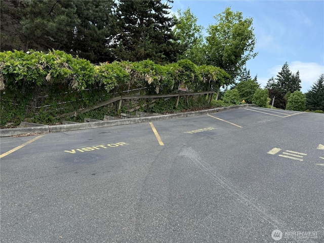 19428 N Aurora Ave Unit 236, Shoreline, WA 98133 - uncovered parking lot with view of scattered trees