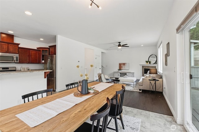 4246 Stonecrest Ct, Bellingham, WA 98226 - dining area with ceiling fan, a fireplace, and recessed lighting