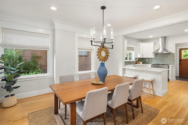 2836 32nd Ave S, Seattle, WA 98144 - dining room featuring healthy amount of natural light, a chandelier, light wood-type flooring, ornamental molding, and recessed lighting