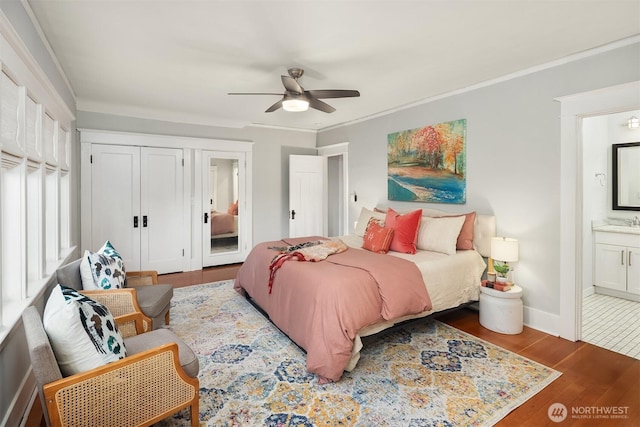2836 32nd Ave S, Seattle, WA 98144 - bedroom featuring wood finished floors, connected bathroom, crown molding, and ceiling fan