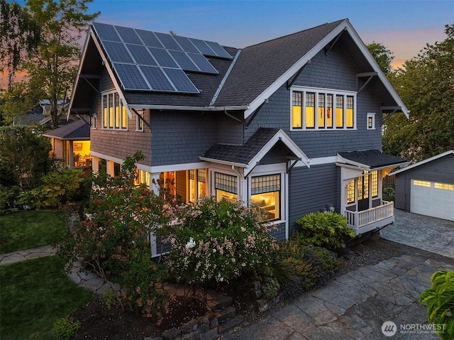 2836 32nd Ave S, Seattle, WA 98144 - view of front facade with solar panels, an outbuilding, roof with shingles, and a garage