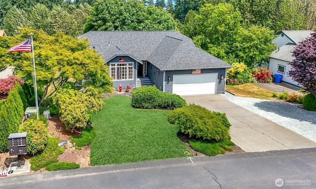15205 197th St E, Orting, WA 98360 - view of front facade with an attached garage, a shingled roof, driveway, and a front lawn