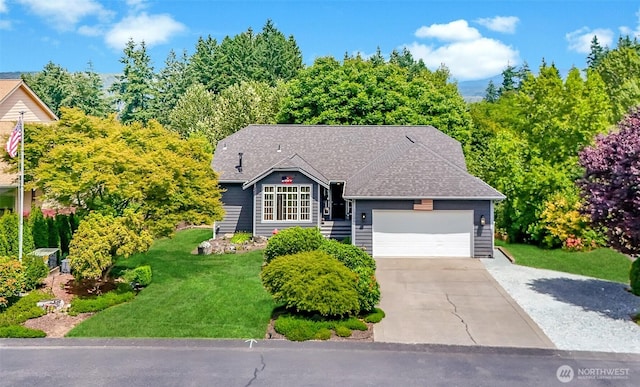 15205 197th St E, Orting, WA 98360 - view of front of property featuring a garage, a front lawn, concrete driveway, and roof with shingles