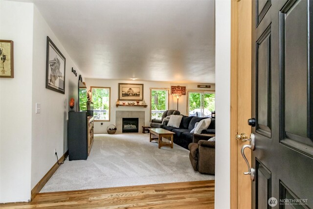 15205 197th St E, Orting, WA 98360 - carpeted living area with plenty of natural light, a fireplace, and wood finished floors