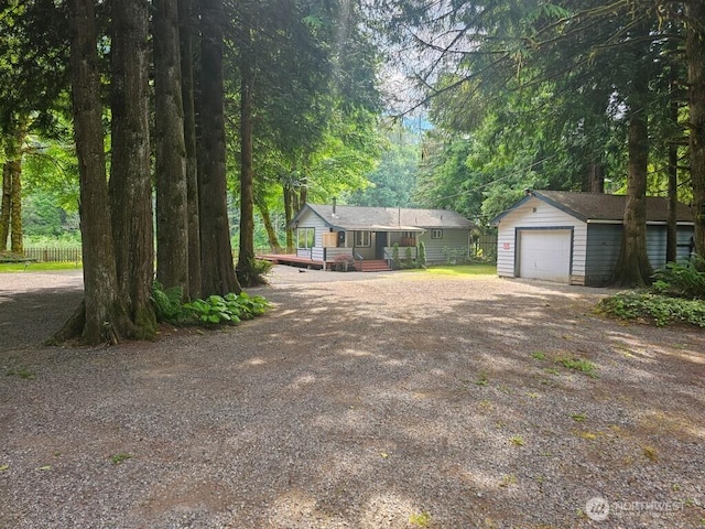 53802 State Route 2, Gold Bar, WA 98251 - ranch-style home featuring an outdoor structure, dirt driveway, a wooden deck, and a detached garage