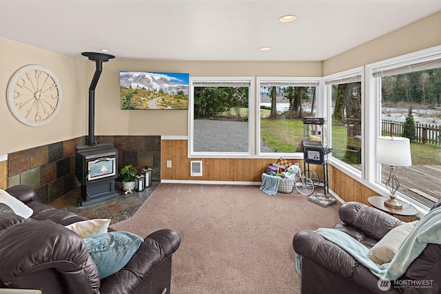 53802 State Route 2, Gold Bar, WA 98251 - carpeted living area featuring a wood stove, wainscoting, healthy amount of natural light, recessed lighting, and wooden walls