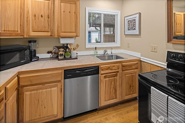 53802 State Route 2, Gold Bar, WA 98251 - kitchen with black appliances, tile countertops, and light wood-style flooring