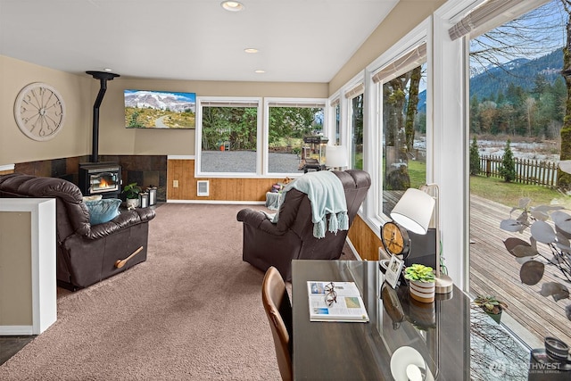 53802 State Route 2, Gold Bar, WA 98251 - living area with a wood stove, healthy amount of natural light, carpet floors, wainscoting, and wooden walls