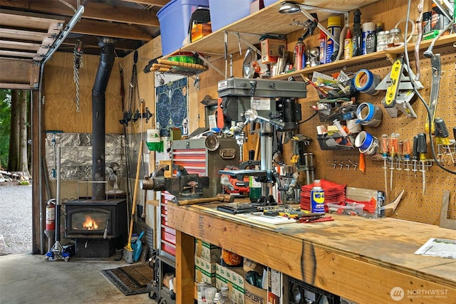 53802 State Route 2, Gold Bar, WA 98251 - miscellaneous room with a workshop area, a wood stove, and concrete floors