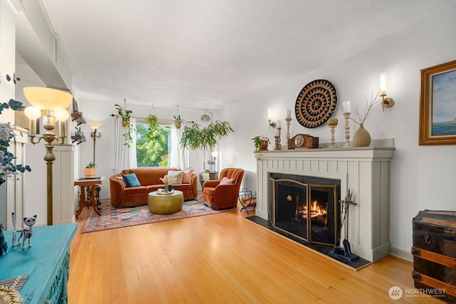 2914 N 15th St, Tacoma, WA 98406 - living area featuring wood finished floors and a warm lit fireplace